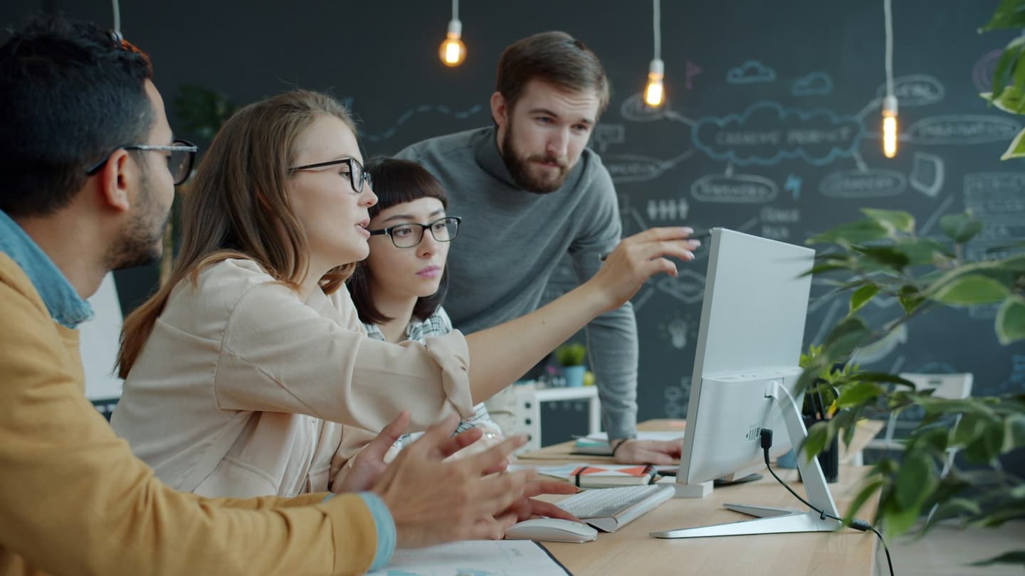 Designers and developers reviewing work together